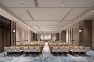 a large room with rows of tables and chairs at Jinmao Grandee Hotel Ningbo in Fenghua