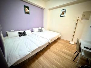 Postelja oz. postelje v sobi nastanitve Huatian B&B
