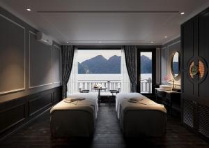 a hotel room with two beds and a window at Majesty Luxury Prime Cruise by Premier Group in Ha Long