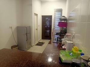 a kitchen with a refrigerator in a room at Hazzar Homestay Sendayan Musslim Only in Kampong Baharu Jimah