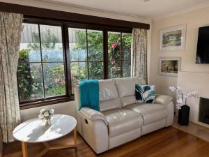 a living room with a couch and a table at Secluded Oasis with Water Views in Sandy Bay