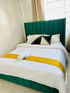 Ένα ή περισσότερα κρεβάτια σε δωμάτιο στο Rispers Homes Nanyuki