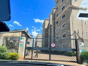 a fence in front of a tall building at Luxe Haven in Eldoret