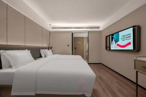 Krevet ili kreveti u jedinici u okviru objekta Echarm Hotel Changsha Electric Power Vocational and Technical College Hyde Park Branch