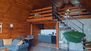 a living room with a spiral staircase in a house at Kera Cottages Kazbegi in Kazbegi