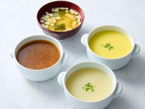 a group of three bowls of soup and a bowl of vegetables at Comfort Hotel Tokyo Kanda in Tokyo