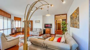 een woonkamer met een bank en een open haard bij Lusso & Relax - 3 Camere, Jacuzzi, Parcheggio in Turijn