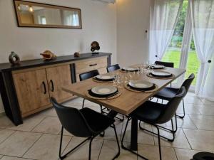 a dining room with a table with chairs and a mirror at Chez Katy in Ban-sur-Meurthe-Clefcy +14 photos