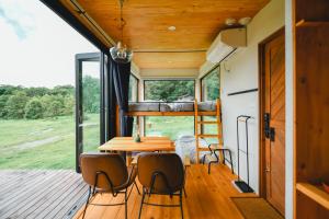 a tiny house with a bunk bed on the deck at ザ ノマド 八ヶ岳 in Hokuto
