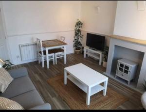 a living room with a couch and a table at Number 20 in Keiss