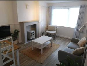 a living room with a couch and a coffee table at Number 20 in Keiss