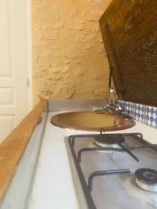 a kitchen with a stove and a stove top at Charmante petite maison pour deux in Badecon-le-Pin +3 photos