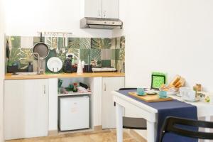 a kitchen with a table and a counter top at Meridiem in Molfetta