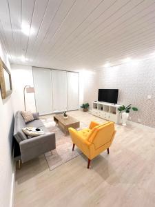 a living room with a couch and a yellow chair at Amazing beachfront condo at Tides on Hollywood Beach Luxury Resort in Hollywood