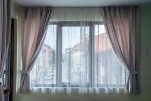 a window with a view of a city at Bansko Ski Apartment in Bansko