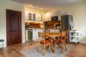 a kitchen with a table and chairs and a refrigerator at Bansko Ski Apartment in Bansko