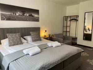 a bedroom with a large bed with two pillows at Willa Torfowa in Wisła