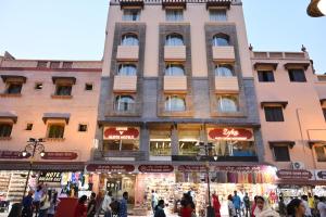 a large building with people walking in front of it at Abode By Aliste Hotels- 2 minutes walking to Golden Temple, Amritsar in Amritsar