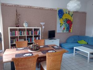 a living room with a table and a blue couch at Ferienwohnung Markert in Blankenburg