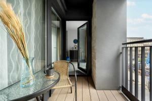 a balcony with a table and a vase on it at Lux Traugutta Apartment with Air Conditioning and Parking by Noclegi Renters in Wrocław