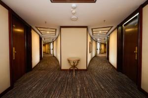 a corridor with a table in the middle of a hallway at Grand Hotel Bucharest in Bucharest