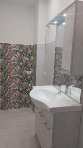 a white bathroom with a sink and a mirror at Case Vacanze Rodi Garganico in Rodi Garganico +30 photos