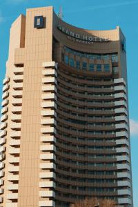 a building with a sign on the top of it at Grand Hotel Bucharest in Bucharest