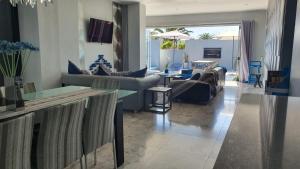 a living room with couches and a table at Marble Blue in Cape Town