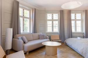 a living room with a couch and a bed at Spacious Apartment on Lively & Vibrant Street in Copenhagen