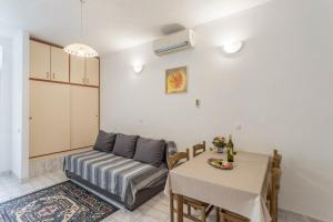 a living room with a couch and a table at Apartments Vedra in Baška Voda