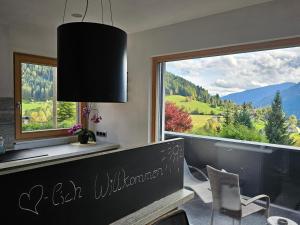 a dining room with a large window with a view at HET Lounge in Radenthein