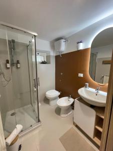 a bathroom with a shower and a toilet and a sink at Appartamento in Centro Living Pescara in Pescara +41 photos