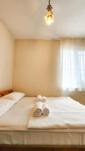 a bedroom with a bed with towels on it at Oli Kazdağları in Biller +21 photos