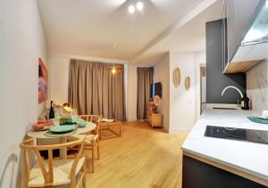 a kitchen and living room with a table and chairs at Silvic Jable in Corralejo