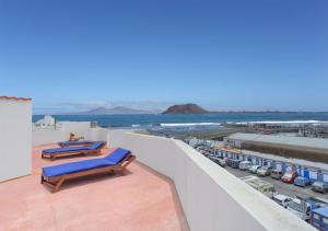 a balcony with lounge chairs and a view of the ocean at Silvic Jable in Corralejo