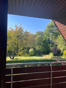 a view of a park from a porch at Haus Otto in Großhansdorf