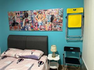 a bedroom with a bed with a picture on the wall at Riveria City KL Sentral in Kuala Lumpur +5 photos