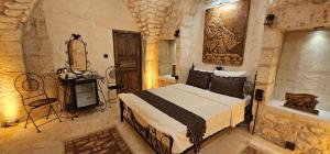 a bedroom with a bed and a television in a room at Cleopatra Antique Hotel in Urfa