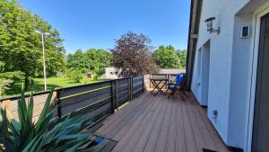 a deck with a table and chairs on a house at Ferienwohnung Ollywood Hill in Halbs