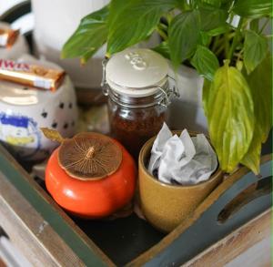 a table with a tomato and a jar and a plant at Stamford Lodge in Stamford +28 photos