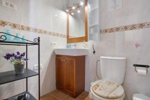 a small bathroom with a toilet and a sink at Los Secretos De San Marcos Seaview in San Marcos +23 photos