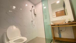 a bathroom with a shower and a toilet and a sink at A Plus Deluxe Hotel in Ko Lipe