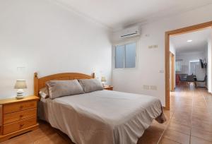 a bedroom with a bed and a desk and a window at One Life One Dream Gran Canaria in Carrizal