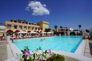 a large swimming pool with people swimming in it at Messapia Hotel in Marina di Leuca