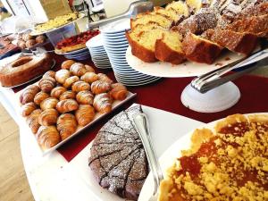 a table full of different types of bread and pastries at Messapia Hotel in Marina di Leuca