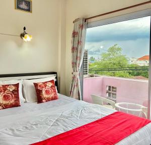a bedroom with a bed and a large window at Home One Love Ayutthaya GH in Phra Nakhon Si Ayutthaya
