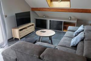 a living room with a couch and a table at Montricher Karellis, à 5 min de Saint Jean de Maurienne in Montricher-Albanne