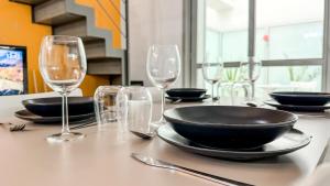 a table with empty glasses and a plate on it at Loft Stadio - Parking, Gym & Comfort in Turin