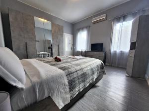 a bedroom with a large bed and a large mirror at Alloggio M&M in Padova