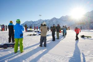 a group of people standing around in the snow at Brici's House 69 - Mountain Apartment Tonale in Passo del Tonale